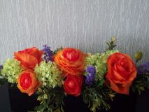 Cemetery flowers in a long narrow tray